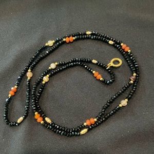 Very reflective gorgeous black necklace with semi precious stones.
